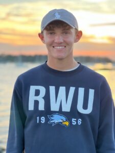 Young man in RWU sweatshirt at sunset