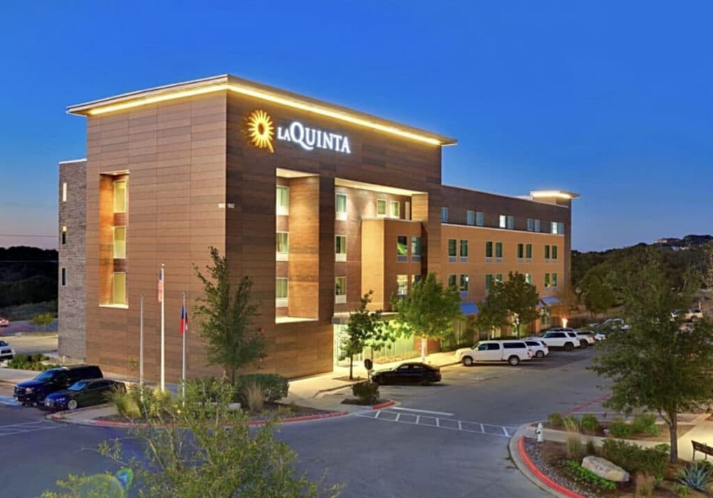 La Quinta hotel exterior at dusk with parking lot